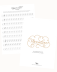 Flat-lay of two printed pages from the Monoline Lettering Guide by Tom’s Studio. One page shows the decorative title cover, and the other features uppercase alphabet tracing exercises.