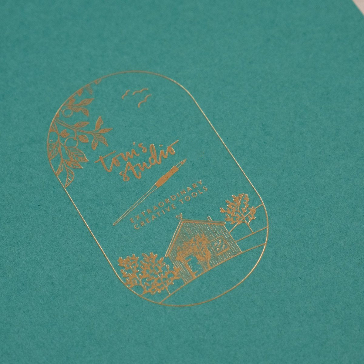 Detail shot of the gold foil on the cover of Tom's Studio A5 calligraphy practice pad