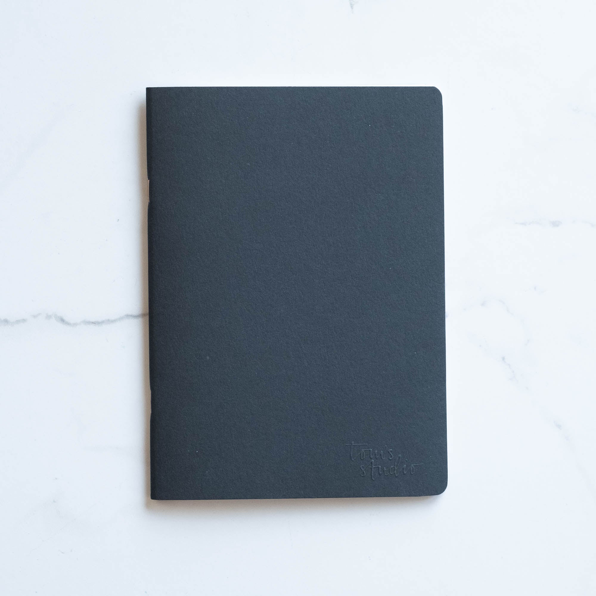 Tom's Studio x Coffeenotes A5 Notebook in Black, made from recycled coffee cups and eco-friendly materials.