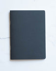 Tom's Studio x Coffeenotes A5 Notebook in Black, made from recycled coffee cups and eco-friendly materials.