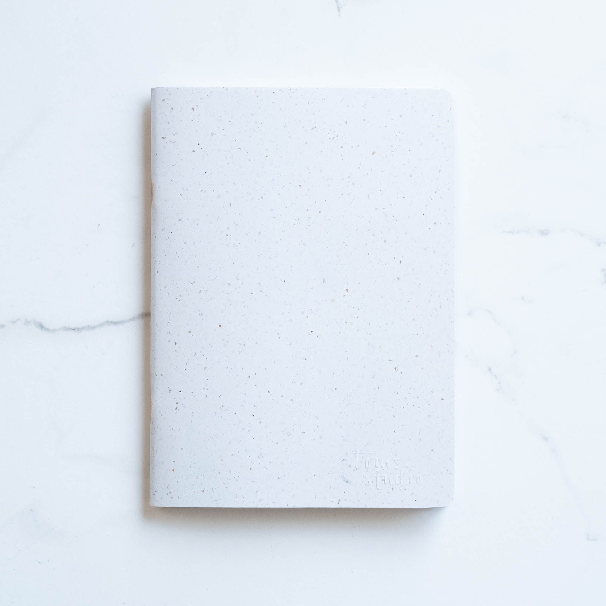 Tom's Studio x Coffeenotes A5 Notebook in 'Grounds' white, made from recycled coffee cups and eco-friendly materials.