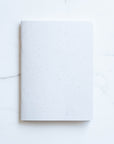 Tom's Studio x Coffeenotes A5 Notebook in 'Grounds' white, made from recycled coffee cups and eco-friendly materials.