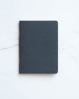 Tom's Studio x Coffeenotes A6 Notebook in Black, made from recycled coffee cups and eco-friendly materials.
