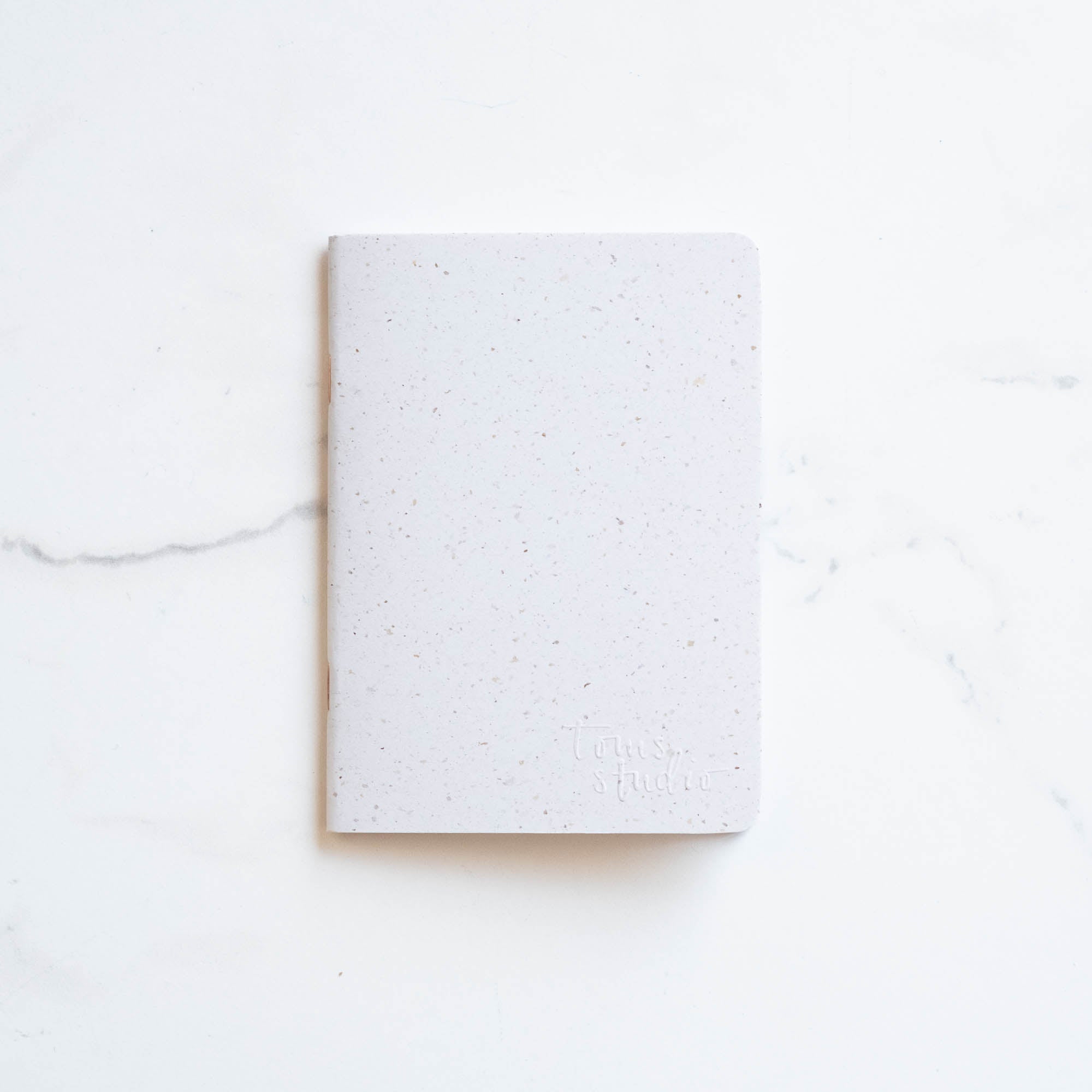 Tom's Studio x Coffeenotes A6 Notebook in 'Grounds' white, made from recycled coffee cups and eco-friendly materials.