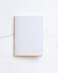 Tom's Studio x Coffeenotes A6 Notebook in 'Grounds' white, made from recycled coffee cups and eco-friendly materials.