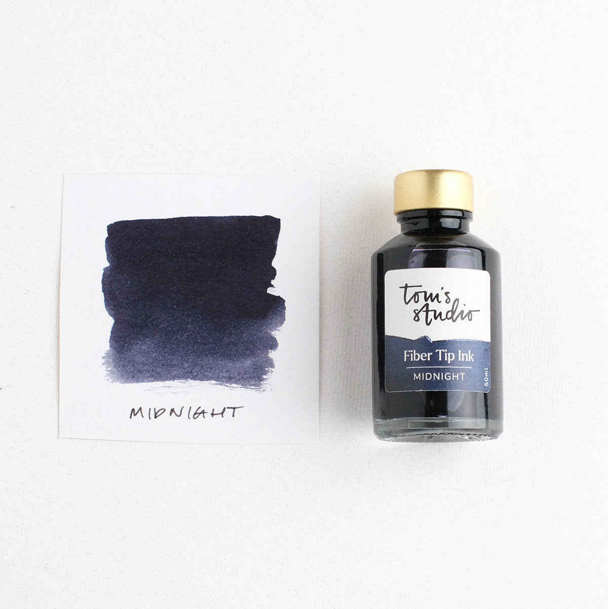 Toms Studio Fibre Tip Ink in Midnight – shown swatched on paper and in the bottle