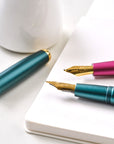 Detail shot showing the Zoom fountain pen nib fitted in the Studio Fountain Pen in Ivy, and Fude fountain pen nib fitted in the Studio Fountain Pen in Mulberry
