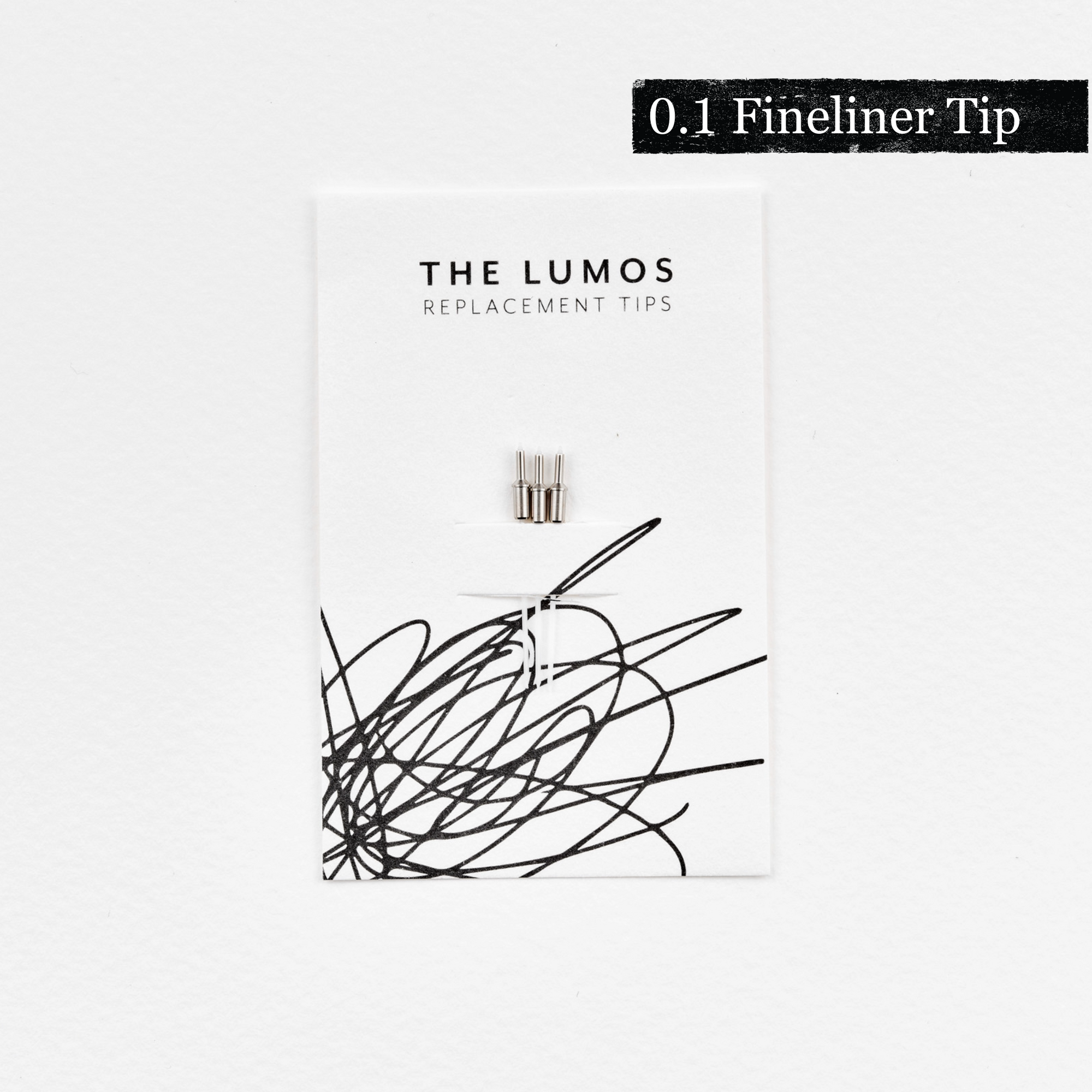 A pack of three Lumos 0.1mm fineliner replacement tips attached to a white backing card. The card features 'THE LUMOS REPLACEMENT TIPS' in uppercase black letters at the top, with an abstract black ink scribble design in the lower half. A black textured label in the upper right corner displays '0.1 Fineliner Tip' in white text.