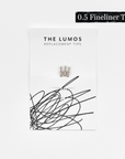 A pack of three Lumos 0.5mm fineliner replacement tips attached to a white backing card. The card features 'THE LUMOS REPLACEMENT TIPS' in uppercase black letters at the top, with an abstract black ink scribble design in the lower half. A black textured label in the upper right corner displays '0.5 Fineliner Tip' in white text.