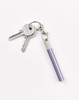 A Lumos Loop Lid attached to a Lilac Lumos Mini pen and clipped onto a keyring, displayed on a plain white background.
