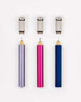 A display of three Lumos Mini pens with their Lumos Loop Lids removed, showing the internal interchangeable tips. The components are arranged to highlight their modular and customizable design.