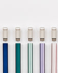 A lineup of multiple Lumos Mini pens in a variety of colours each pictured with a Lumos Loop Lid, arranged neatly in a row on a white background.