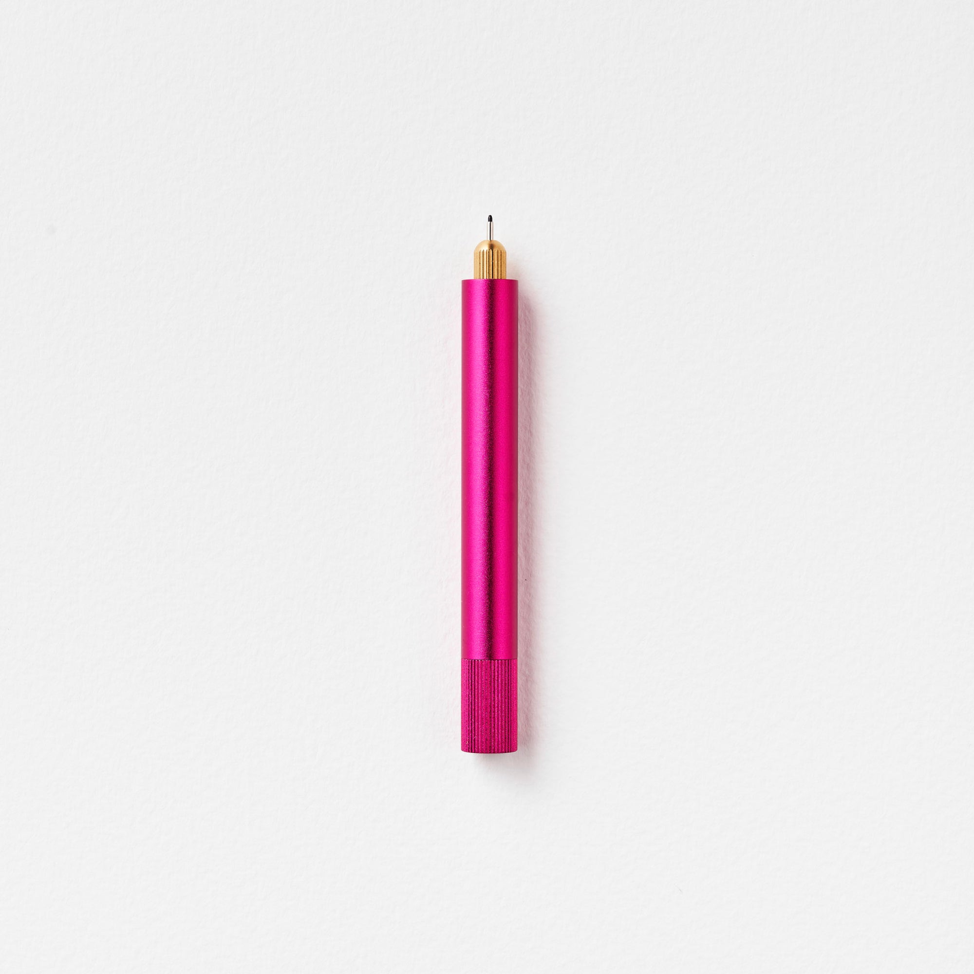 The Lumos Mini Refillable Pen in Raspberry on white background