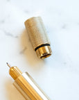The Lumos refillable pen special edition in brass with knurled lid and fineliner tip