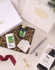 Contents of the Lumos Pro Duo Gift Set including: Lumos Pro Duo refillable pen in Lilac, 50ml bottle of Fountain Pen Ink in New Forest, the Studio Pad and Butterfly Brass Pen Rest