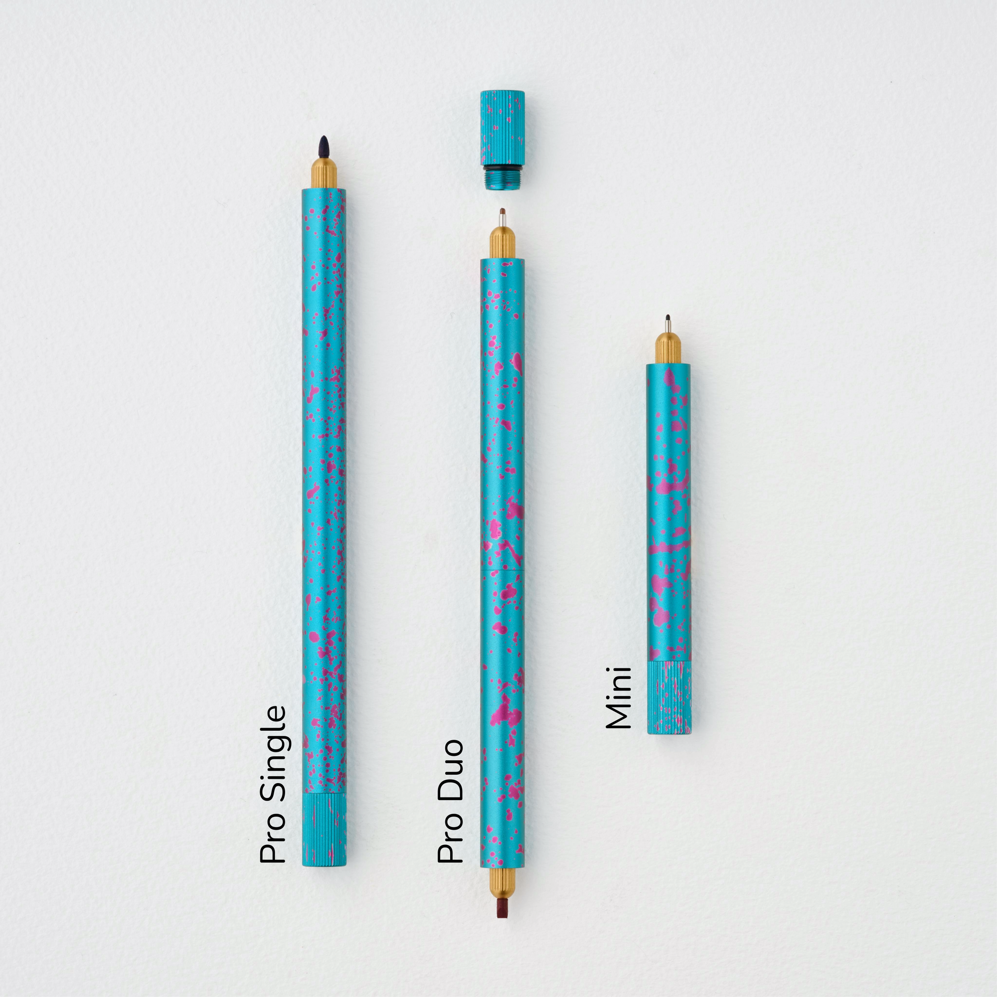 Lumos Splash Pro Single, Pro Duo, and Mini pens in Blue Raspberry blue with pink splatter, shown uncapped on a white background with labels.