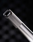 Detail shot of the Titanium Lumos loop lid, showcasing its grooved texture, bead-blasted finish, and signature oblong loop design.