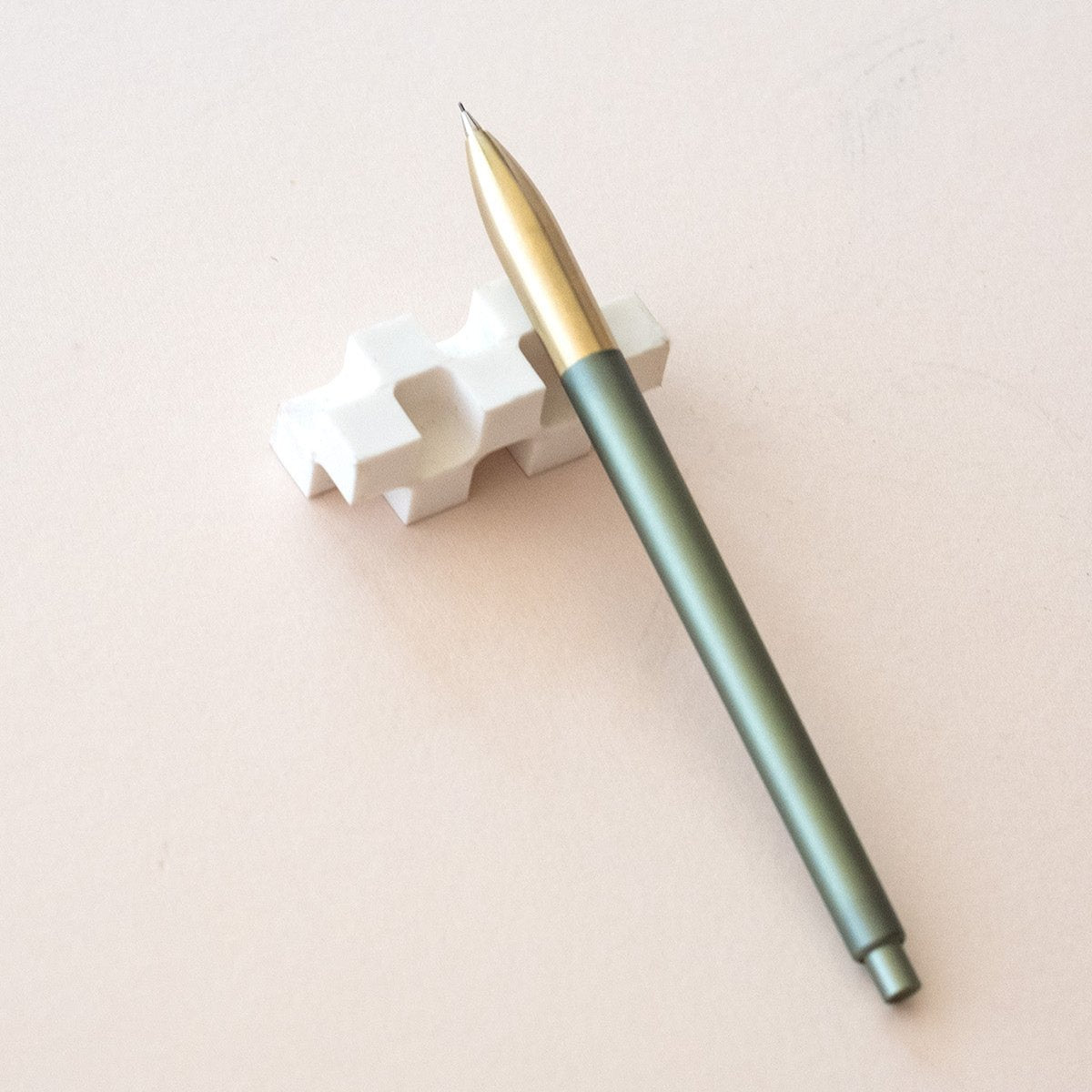 Tom's Studio Mechanical Pencil in Sage, resting on the World's Best Eraser