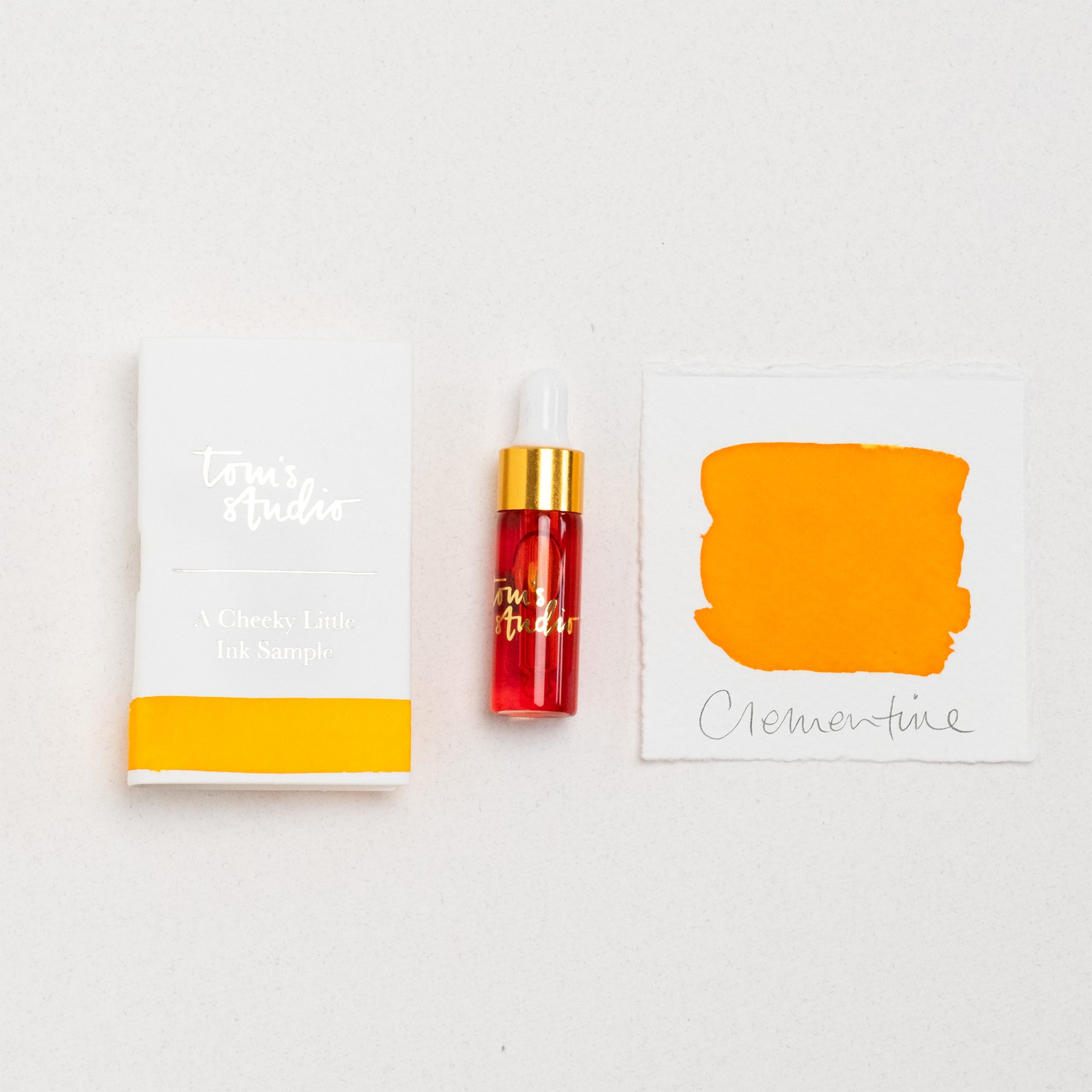 Tom's Studio Clementine Mini Fountain Pen Ink – featuring the packaging, bottle with pipette in lid and swatch