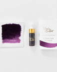 A mini ink sample bottle of Damson purple fountain pen ink by Tom’s Studio, displayed alongside a swatch of the ink on textured paper and its matching packaging. The bottle is small, with a gold cap and a white pipette dropper, and features 'Tom’s Studio' in gold lettering. The ink swatch shows a rich, shimmering hue with a gradient from deep to lighter tones. The packaging, a small white card, has 'Tom’s Studio' embossed in gold at the top, with a brushstroke of the ink colour at the bottom.