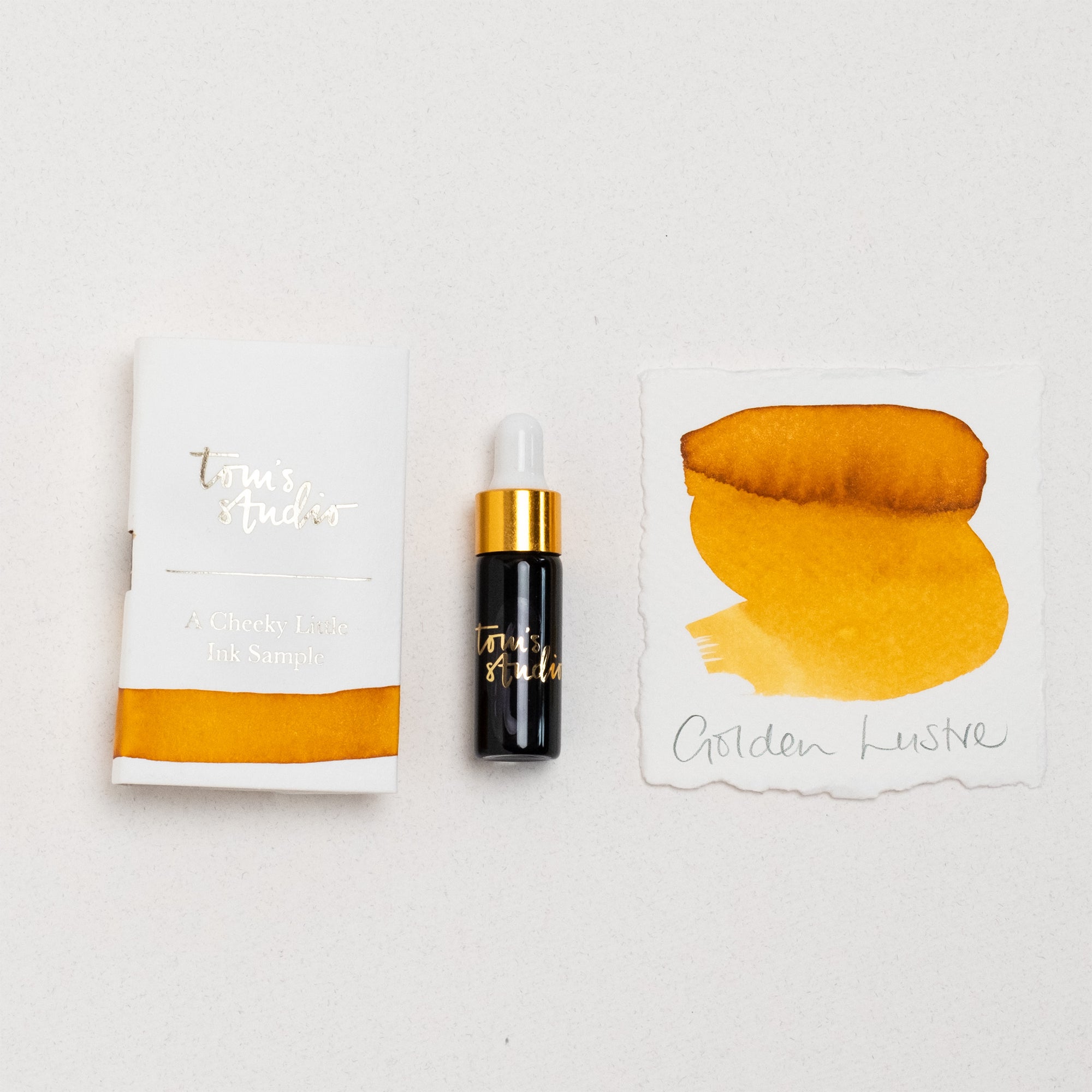 Tom's Studio Golden Lustre Mini Shimmer Fountain Pen Ink – featuring the packaging, bottle with pipette in lid and swatch