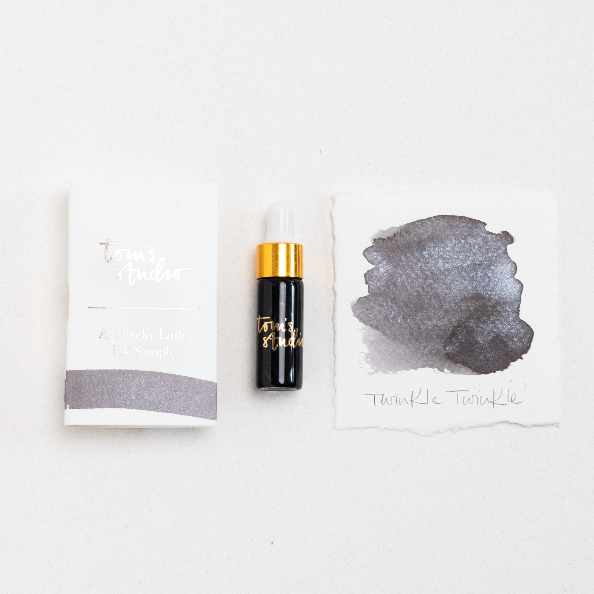 Tom's Studio Twinkle Twinkle Mini Shimmer Fountain Pen Ink – featuring the packaging, bottle with pipette in lid and swatch