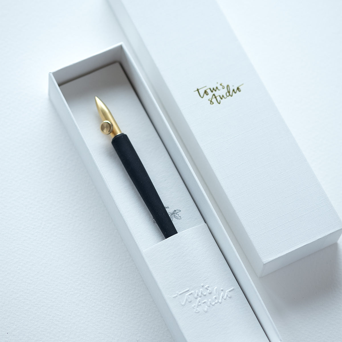 The One-Dip-Nib in Brass, shown in packaging