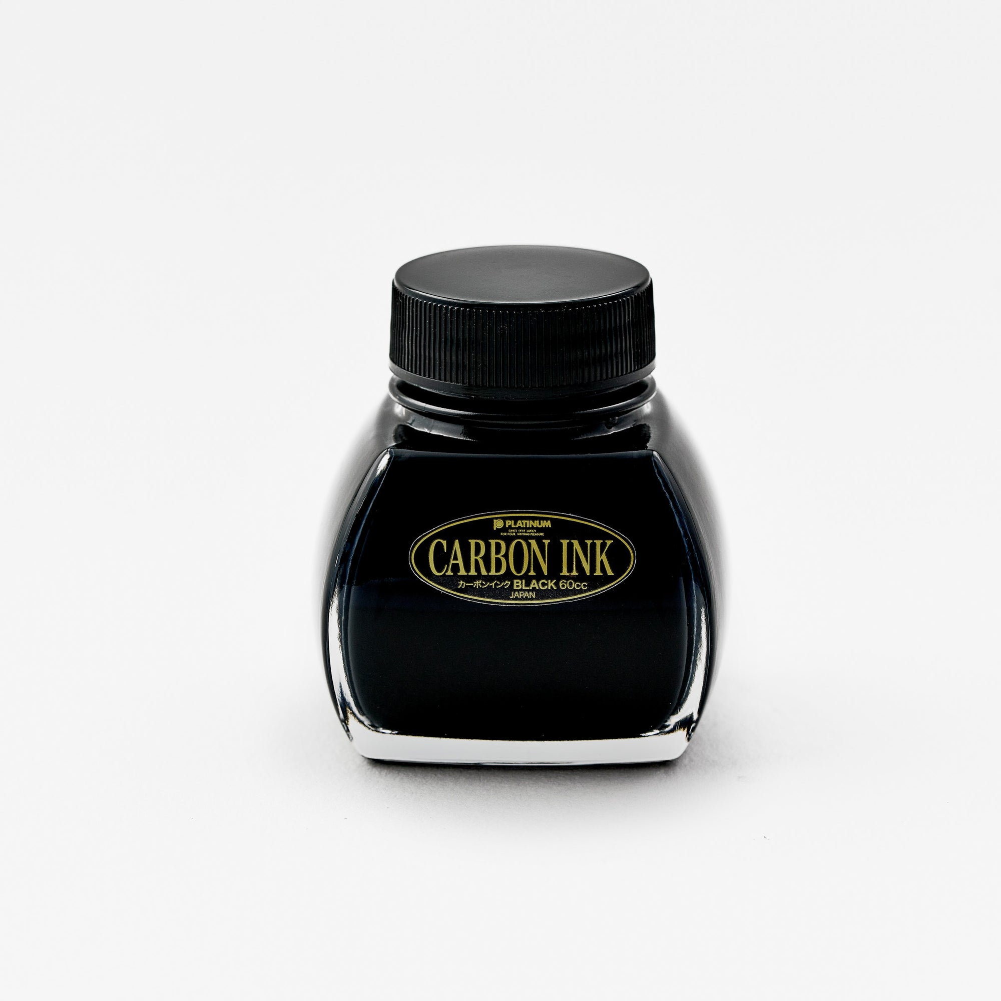 A front-facing image of the Platinum Carbon Ink bottle. The label is fully visible, featuring the "Carbon Ink" logo in gold lettering against a black background. The glass bottle has a distinctive shape, and the deep black ink inside is prominently displayed.