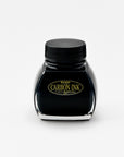 A front-facing image of the Platinum Carbon Ink bottle. The label is fully visible, featuring the "Carbon Ink" logo in gold lettering against a black background. The glass bottle has a distinctive shape, and the deep black ink inside is prominently displayed.