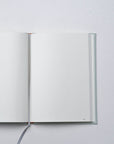 Semikolon A5 notebook in Moss green with dotted pages, page marker ribbon and premium linen bound cover.