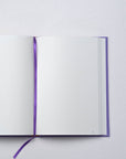 Semikolon A5 notebook in Lilac (purple) with plain pages, page marker ribbon and premium linen bound cover.