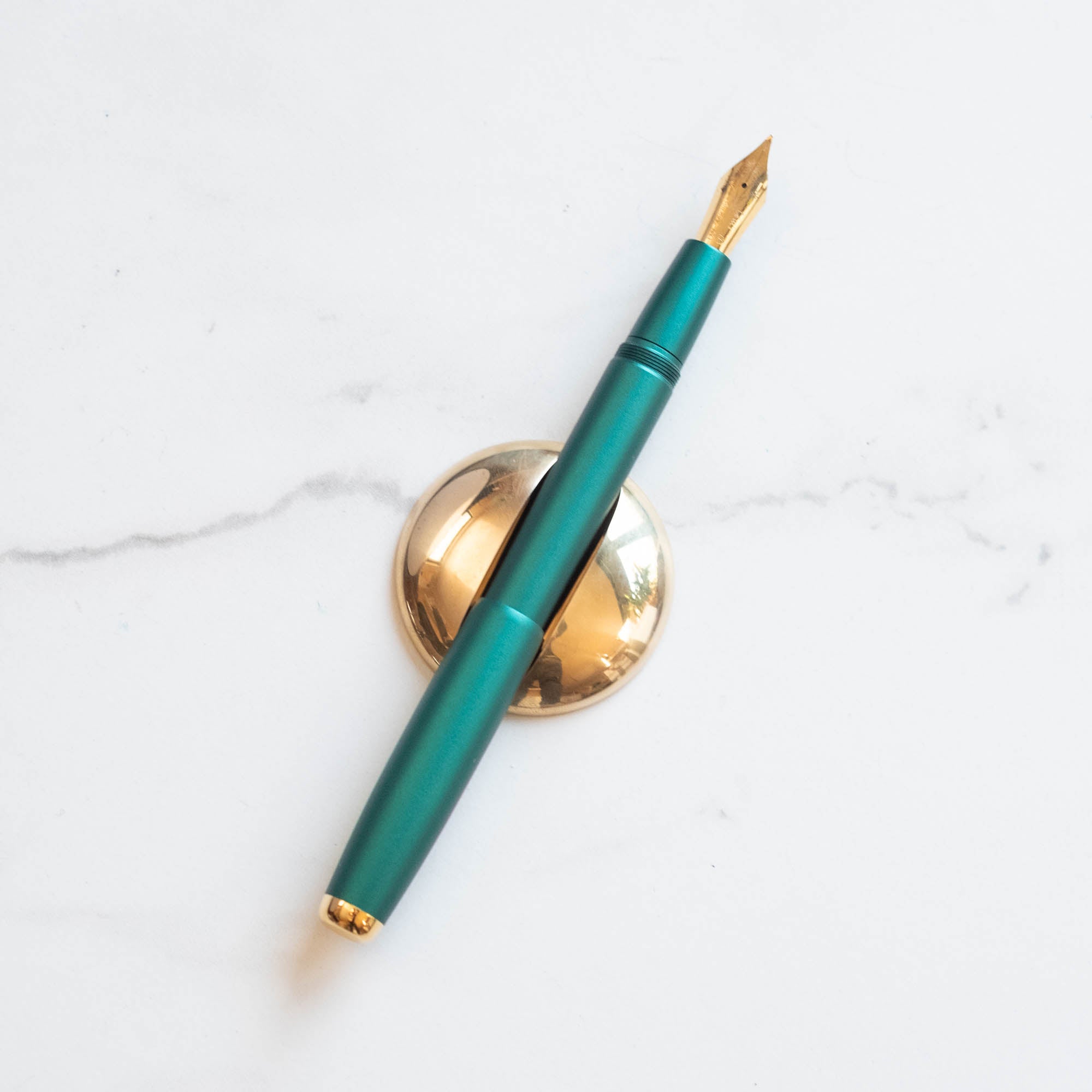 Solid Brass Pen Rest pictured with Studio Fountain Pen in Ivy