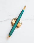Solid Brass Pen Rest pictured with Studio Fountain Pen in Ivy