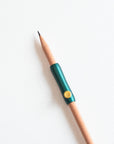 The Poise Pencil Grip Extender in Ivy shown on a standard pencil.