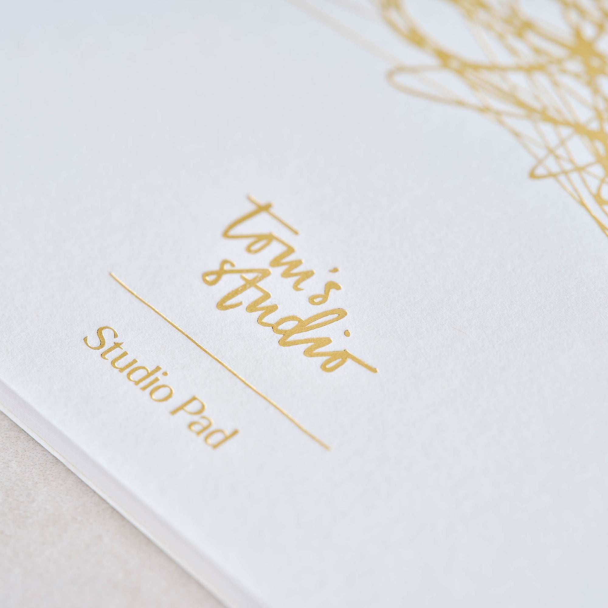Detail shot of the cover for the Studio Pad refillable, customisable notebook and organiser with gold foil