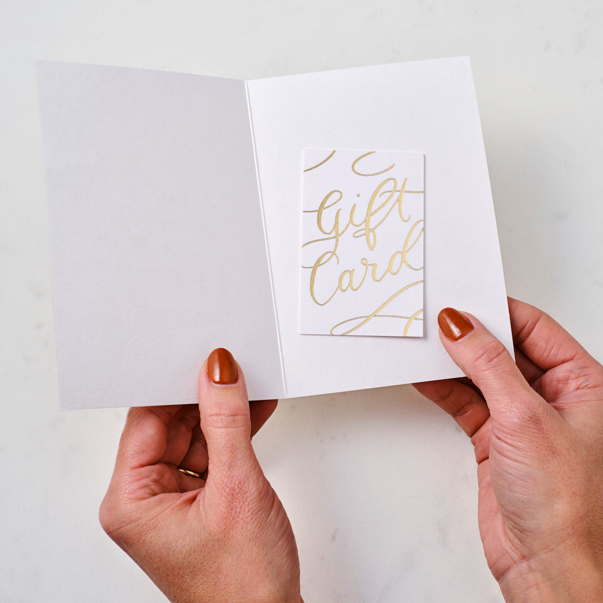 Gold foiled printed Tom's Studio gift card inserted in a greetings card
