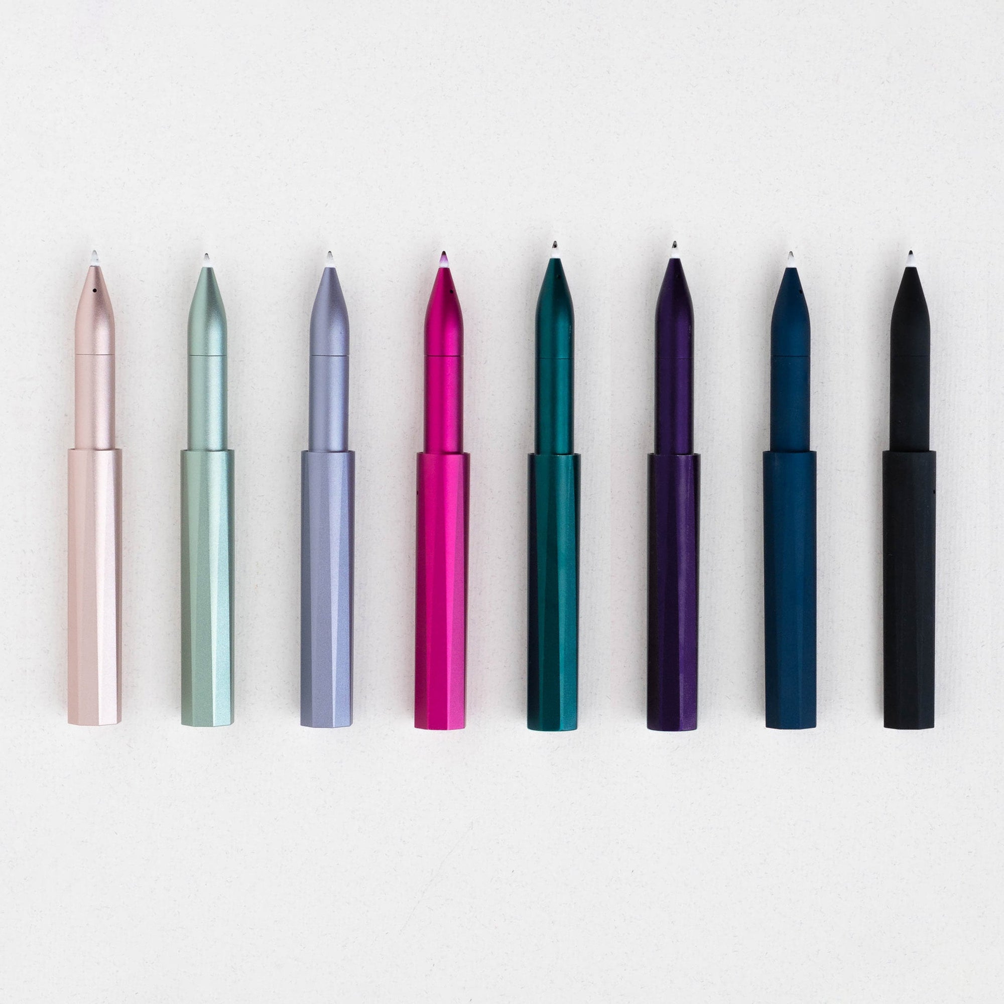 The Wren refillable everyday writing pen in (top to bottom) Blush, Sage, Lilac, Raspberry, Ivy, Iris, Midnight, Black