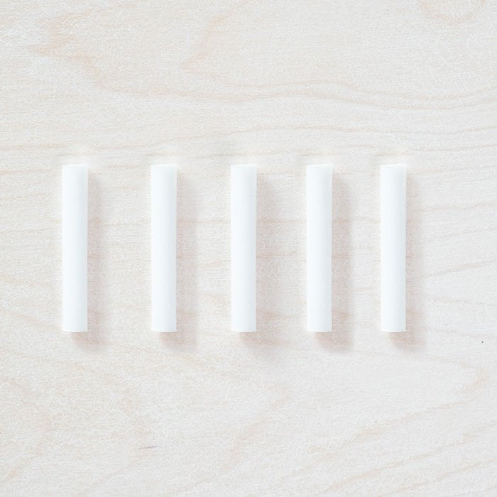 5 individual spare ink reservoirs for a Wren Pen displayed on a light wooden surface.