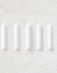 5 individual spare ink reservoirs for a Wren Pen displayed on a light wooden surface.