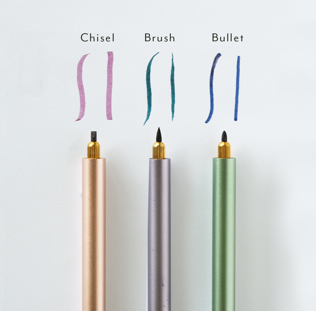 Three Lumos pens installed with three different sized brush tips (Chisel, Brush and Bullet). Pen and line of tip annotated to show size and displayed on a white background.