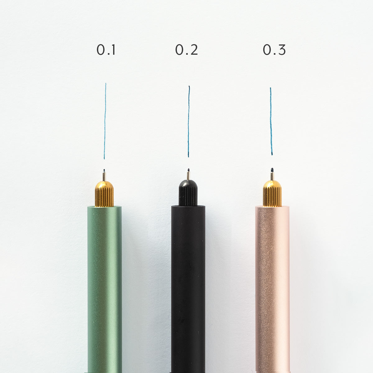 Three Lumos pens installed with three different sized fineliner tips (0.1. 0.2 & 0.3). Pen and line of tip annotated to show size and displayed on a white background.