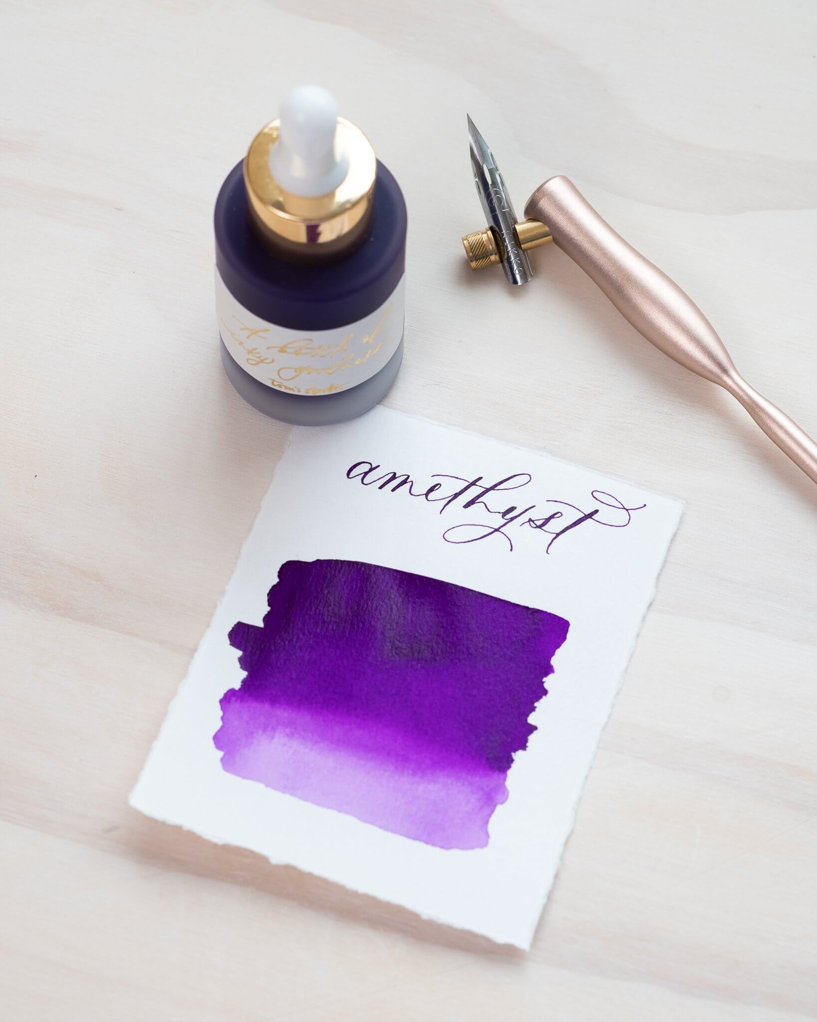 Amethyst - Calligraphy Ink in bottle with swatch showing the ink colour