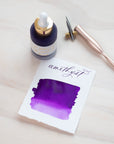 Amethyst - Calligraphy Ink in bottle with swatch showing the ink colour