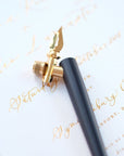 The Original Flourish Straight Calligraphy Pen in Black shown on a sample of calligraphy