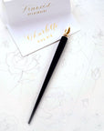 The Original Flourish Straight Calligraphy Pen in Black shown with calligraphy/hand lettered place cards