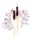Two Bloom calligraphy pens in Dark Mulberry – both oblique and straight nib setting on a background of illustrations in ink