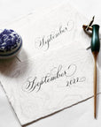 The Bloom calligraphy pen in Ivy with oblique nib setting shown with an example of calligraphy lettering