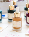 A selection of Tom's Studio Calligraphy Inks with colour swatches