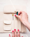 A calligrapher removing an oblique calligraphy pen from the Leather Pen Roll handmade by Edward de Lacy