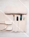 Leather Pen Roll handmade by Edward de Lacy with a selection of pens stored inside the pockets
